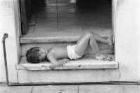 child resting on doorstep